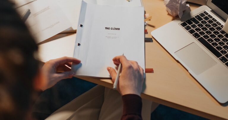 video script template: image of a scriptwriter sitting with a video script at a desk