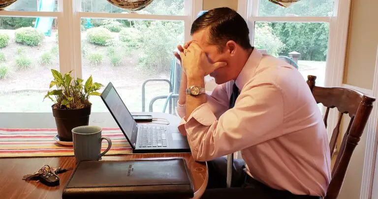 concerned-millenial-hunched-over-his-laptop-UEL8W6T